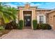 Inviting front entrance with stone accents, manicured shrubs, and a charming 'hello' wreath on a dark-colored door at 3753 Heirloom Rose Pl, Oviedo, FL 32766