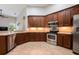 Spacious kitchen featuring stainless steel appliances and ample cabinet space at 3753 Heirloom Rose Pl, Oviedo, FL 32766
