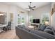 Bright living room boasts tile floors, a ceiling fan, and a comfortable gray sofa at 3753 Heirloom Rose Pl, Oviedo, FL 32766