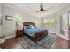 Spacious main bedroom with a ceiling fan, wood floors, and natural light from multiple windows at 3753 Heirloom Rose Pl, Oviedo, FL 32766
