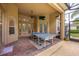 Covered patio area featuring a ping pong table, ceiling fan, and access to outdoor entertainment space at 3753 Heirloom Rose Pl, Oviedo, FL 32766