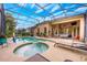 Relaxing pool area with a jacuzzi, lounge chairs, a covered patio and an adjacent well-manicured patio at 3753 Heirloom Rose Pl, Oviedo, FL 32766