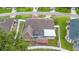Aerial view of the house with a screened patio, outbuilding and fenced backyard at 40 Hollow Pine Dr, Debary, FL 32713