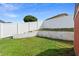 Backyard with a tiered block retaining wall and a tall white vinyl fence at 40 Hollow Pine Dr, Debary, FL 32713