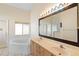 Bathroom featuring double sinks, a soaking tub, and natural light at 40 Hollow Pine Dr, Debary, FL 32713