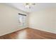 Neutral bedroom with hardwood floors, a ceiling fan, and a large window at 40 Hollow Pine Dr, Debary, FL 32713