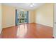 Bright bedroom with a large window, neutral walls and wood flooring under a ceiling fan at 40 Hollow Pine Dr, Debary, FL 32713