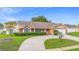 Charming one-story brick home with a manicured lawn and a circular driveway at 40 Hollow Pine Dr, Debary, FL 32713