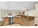 Open-concept kitchen featuring stainless steel dishwasher, granite countertops, and ample natural light at 40 Hollow Pine Dr, Debary, FL 32713