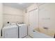 Clean laundry room with washer, dryer, shelving, and utility sink at 40 Hollow Pine Dr, Debary, FL 32713