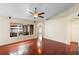 Spacious living room featuring hardwood floors, ceiling fan, and view of screened-in patio at 40 Hollow Pine Dr, Debary, FL 32713