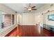 Open living room featuring hardwood floors, large windows, and seamless transition to the kitchen at 40 Hollow Pine Dr, Debary, FL 32713