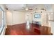 Open living room boasts hardwood floors, ceiling fan, large windows, and an entertainment center at 40 Hollow Pine Dr, Debary, FL 32713