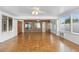 Bright sunroom with tile floors, exposed brick, and multiple windows with vertical blinds at 40 Hollow Pine Dr, Debary, FL 32713