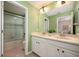 Bathroom featuring a double vanity, bathtub with shower, and stylish mirror at 411 Evening Sky Dr, Oviedo, FL 32765