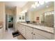 Bright bathroom features double sinks with granite countertops, large mirror, and walk-in shower at 411 Evening Sky Dr, Oviedo, FL 32765