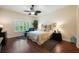 Tranquil bedroom with a ceiling fan, hardwood floors and a window with shutters at 411 Evening Sky Dr, Oviedo, FL 32765