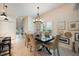 Bright dining room with tile floors, six chairs and a modern chandelier at 411 Evening Sky Dr, Oviedo, FL 32765