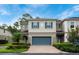 Charming two-story townhome with a brick driveway, blue shutters and a well-manicured lawn at 411 Evening Sky Dr, Oviedo, FL 32765