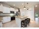 Well-lit kitchen featuring granite countertops, stainless appliances, and counter seating at 411 Evening Sky Dr, Oviedo, FL 32765
