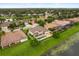 Aerial view of a home with a private pool and lush backyard bordering a tranquil lake with mature trees at 4221 Isle Vista Ave, Belle Isle, FL 32812