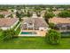 Bird's eye view of a property showcasing a swimming pool, landscaped yard, and proximity to a peaceful lake at 4221 Isle Vista Ave, Belle Isle, FL 32812