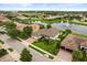 Aerial view of a home in a lakeside community showcasing lush landscaping and a serene water feature at 4221 Isle Vista Ave, Belle Isle, FL 32812