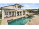 Spacious backyard featuring a sparkling pool, spa, covered patio, and lush landscaping perfect for outdoor living and entertaining at 4221 Isle Vista Ave, Belle Isle, FL 32812