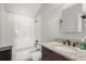 Clean bathroom with a granite countertop, framed mirror, dark vanity, and tiled shower-tub combo at 4221 Isle Vista Ave, Belle Isle, FL 32812
