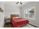 Cozy bedroom with a ceiling fan, wood flooring, and natural light from the window at 4221 Isle Vista Ave, Belle Isle, FL 32812