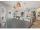 Open dining area with a modern table, wicker chairs, and a view into the kitchen and living room at 4221 Isle Vista Ave, Belle Isle, FL 32812