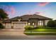 Charming home with a three car garage, a manicured lawn and a stone facade at 4221 Isle Vista Ave, Belle Isle, FL 32812