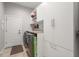 Well-equipped laundry room features front loading washer/dryer and custom cabinets for optimal storage at 4221 Isle Vista Ave, Belle Isle, FL 32812