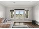 Living room featuring french doors to a balcony, with views of the pond and community at 4221 Isle Vista Ave, Belle Isle, FL 32812