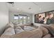 A media room featuring a large sectional sofa, projector, and French doors with exterior views at 4221 Isle Vista Ave, Belle Isle, FL 32812