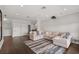 Open-concept living room with hardwood floors, a large sectional sofa, and neutral decor at 4221 Isle Vista Ave, Belle Isle, FL 32812