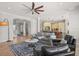 Open-concept living room featuring a ceiling fan, modern furniture, and a view of the kitchen at 4221 Isle Vista Ave, Belle Isle, FL 32812