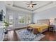 Serene main bedroom features tray ceiling, plantation shutters, and access to the backyard at 4221 Isle Vista Ave, Belle Isle, FL 32812