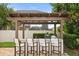 Outdoor kitchen with bar seating perfect for entertaining, featuring built-in grill and views of the surrounding landscape at 4221 Isle Vista Ave, Belle Isle, FL 32812