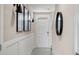 Elegant entryway with modern lighting fixtures, wainscoting, and contemporary decor at 4618 Linda Dr, Lake Wales, FL 33859