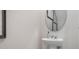 Modern half-bathroom with pedestal sink, updated fixtures, and decorative mirror at 4618 Linda Dr, Lake Wales, FL 33859