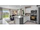 Stylish kitchen showcasing stainless steel appliances, granite counters, and an open layout to the living area at 4618 Linda Dr, Lake Wales, FL 33859