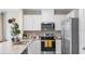 Contemporary kitchen with white cabinetry, stainless steel appliances, and granite countertops at 4618 Linda Dr, Lake Wales, FL 33859