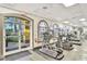 Modern gym with plenty of cardio equipment and natural light at 487 La Mirage St, Davenport, FL 33897