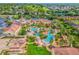 Stunning aerial view of a resort-style pool area with lush landscaping and water features at 487 La Mirage St, Davenport, FL 33897