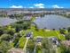 Aerial view of stunning lakefront properties with manicured lawns and private docks at 49 Interlaken Rd, Orlando, FL 32804
