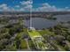 Panoramic aerial shot of a waterfront estate highlighting the expansive lot, lakeside location, and surrounding community amenities at 49 Interlaken Rd, Orlando, FL 32804