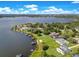 Aerial view featuring luxurious lakefront properties with docks and sprawling lawns at 49 Interlaken Rd, Orlando, FL 32804