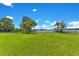 Spacious backyard with plenty of room for recreation, featuring mature shade trees and lake views at 49 Interlaken Rd, Orlando, FL 32804