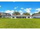 Expansive backyard featuring a well-maintained lawn and a full view of the home's rear facade at 49 Interlaken Rd, Orlando, FL 32804